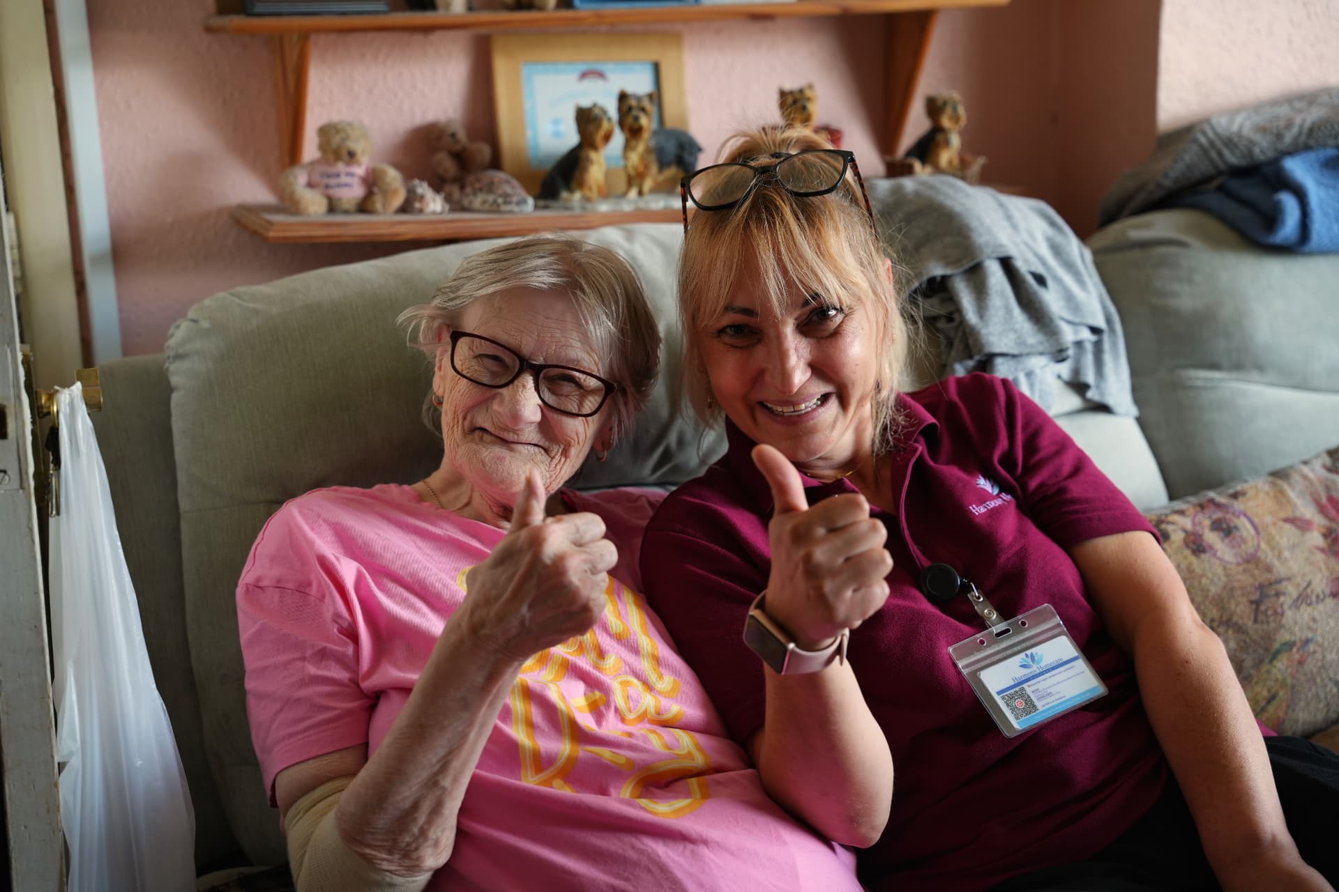 A Harmony carer bringing breakfast in bed to an elderly client at home in Suffolk